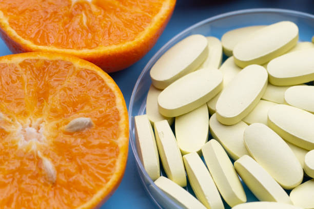 istock Vitamin C pills with  fresh orange citrus fruit 2150750248