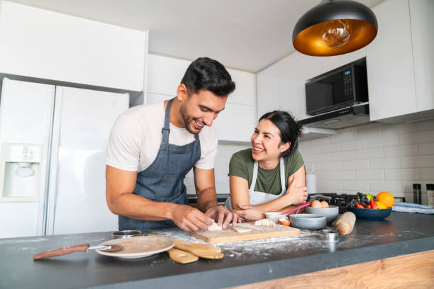 Happy couple baking pastries together at home