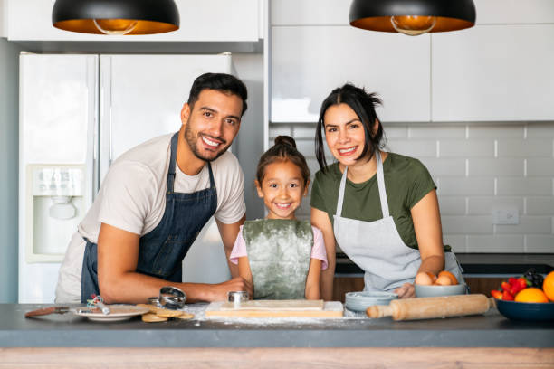 istock Happy family having fun baking at home 2150750454