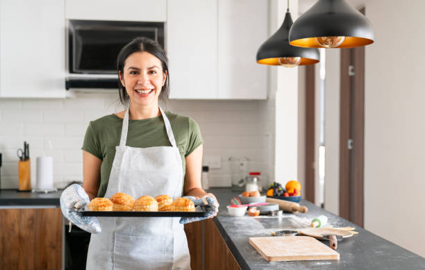 istock Woman looking very happy baking at home 2150750477
