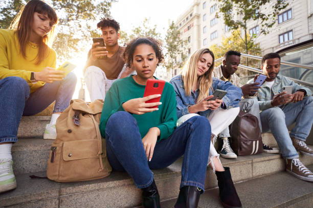 istock Diverse group university friends sitting on street staircase, serious students people using phone. 2150750655
