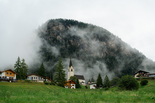 Idyllic village with church tucked in Swiss Alps
