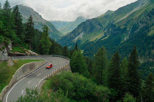 istock Red car on mountain  pass in Swiss Alps in summer 2150751021