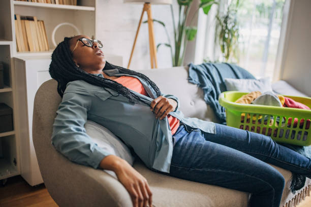 istock Person taking a break on the couch with laundry 2150751232
