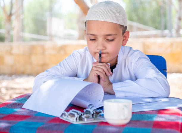 istock ARarbic boy studying his lessons in the park 2150751615