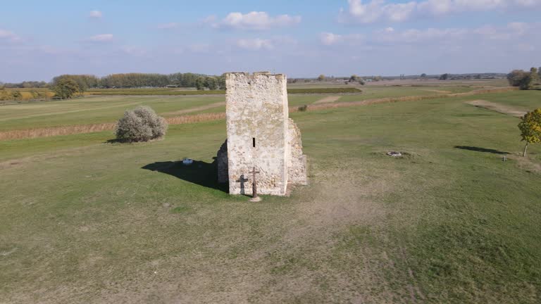 Aerial parallax around ancient stone truncated tower in Soltszentimre, Hungary.