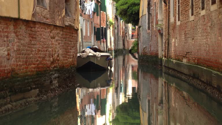 White Boat Parked in Water Canal of Venice