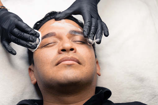 micro pigmentation technique on a latin man's eyebrows