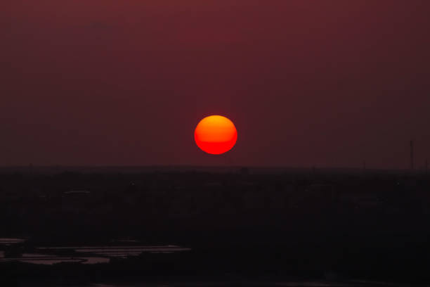 Sunset hour. Big round sun on the horizon of the city of Natal, Rio Grande do Norte, Brazil. Nightfall.