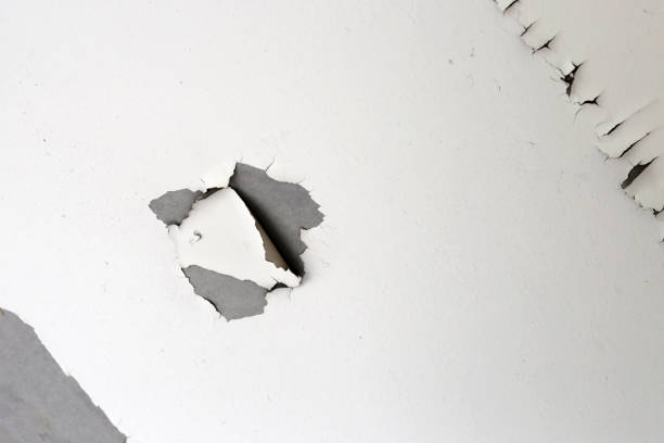 istock White color paint peeling off on ceiling house. Under the roof 2150755531