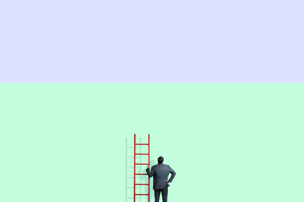 istock Man Holding Ladder Looking Up 2150756123