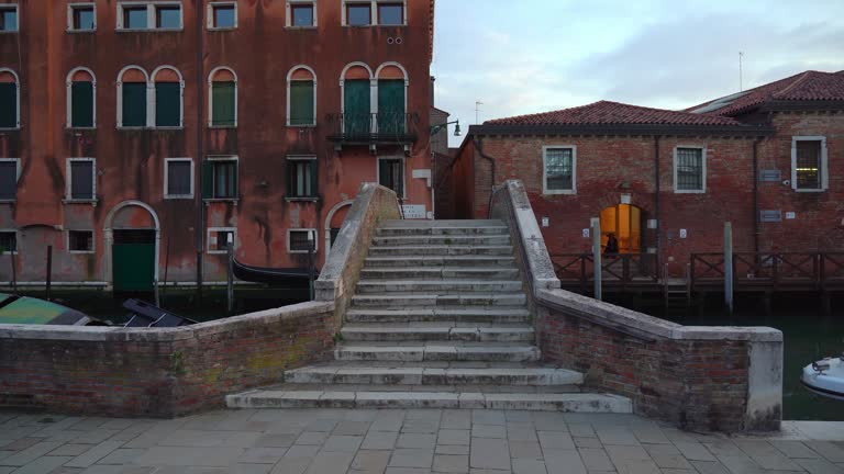 Stone Bridge near Water Canal in Venice During Dusk in Early Spring