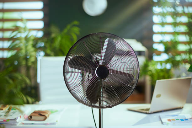 istock metal fan in modern green office 2150760373