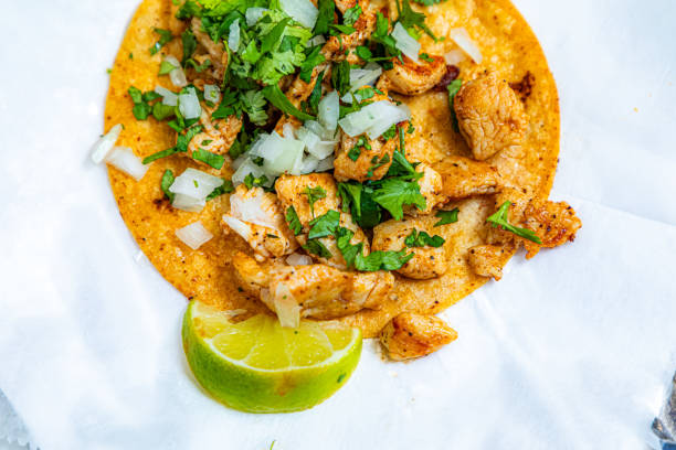 Tasty taco on yellow background, close up