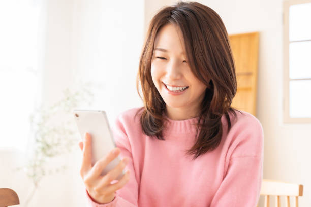 istock Asian woman using a smart phone 2150762940