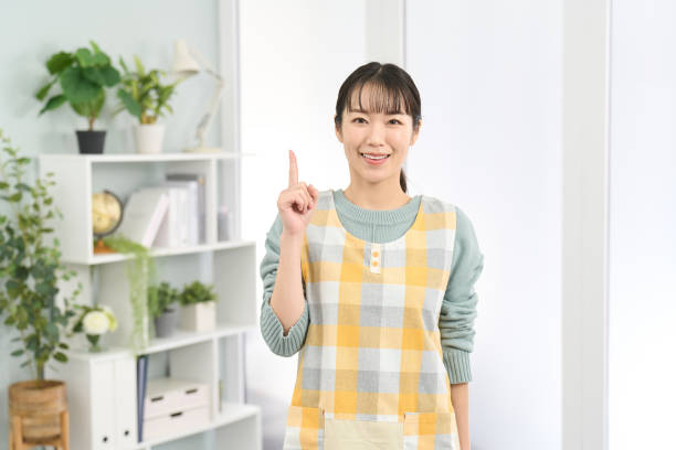 istock A woman wearing an apron pointing with a smile 2150763892