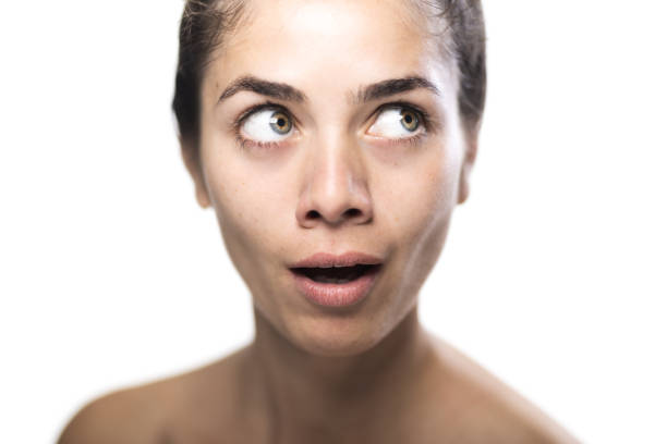 Young woman with a surprised expression in a studio portrait
