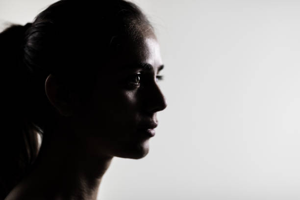 istock Elegant young woman in silhouette, side profile in studio setting 2150763997