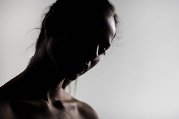 istock Silhouette portrait of a young woman in a studio setting, showcasing subtle emotions 2150764012