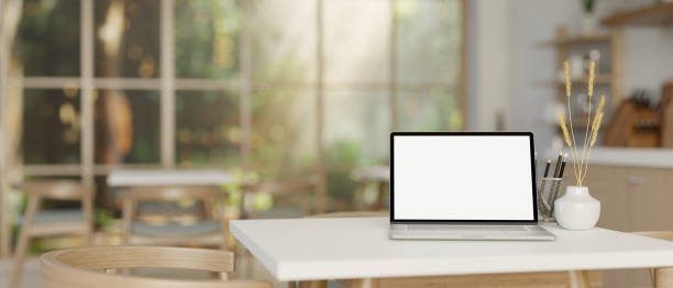 istock An opened laptop computer on a table in cozy contemporary coffee shop or restaurant. 2150765186