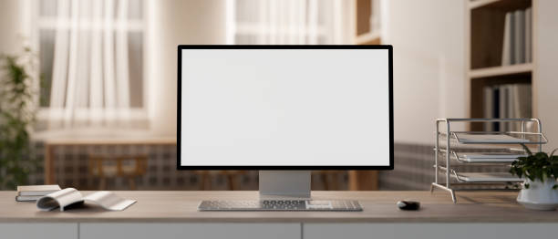 istock A white-screen computer mockup and office supplies on a table in a cozy contemporary office. 2150765216