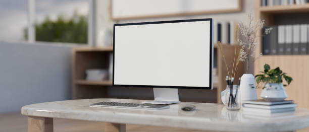 istock A computer white-screen mockup on a luxury marble table in a modern office or home office. 2150765223