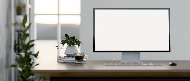 istock A computer desk in a minimal white room features a white-screen computer mockup on the desk. 2150765245