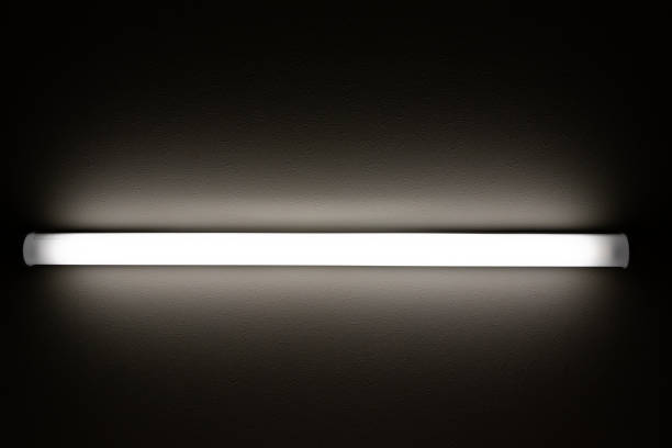 istock A straight tube light on the ceiling illuminates a dark room 2150766516