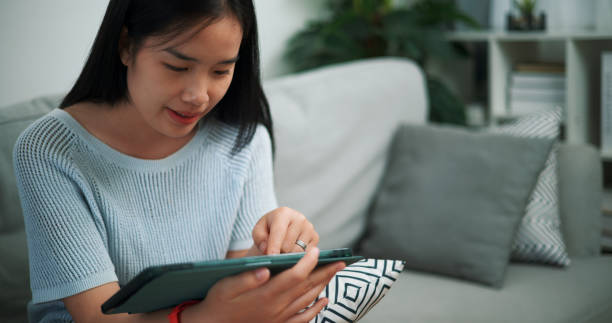 istock Young woman relaxing with digital tablet at home. 2150769447