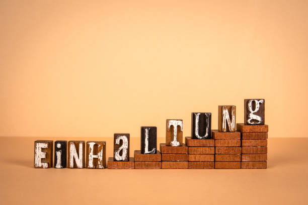 Compliance word in German. Wooden alphabet letters on a light background.
