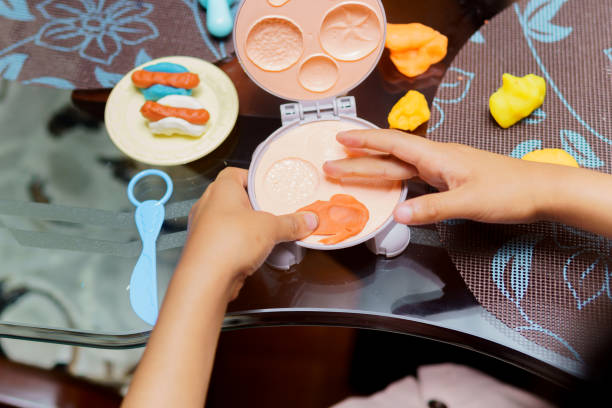 istock A child is playing with a toy kitchen set, including a toy toaster 2150771920