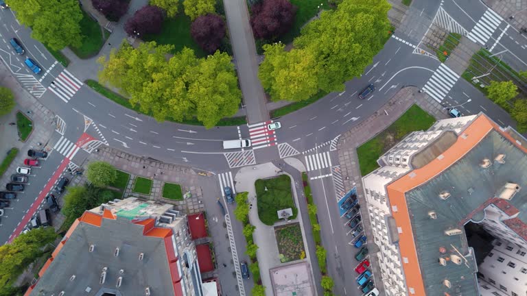 A white van is driving through a large roundabout. Aerial Rotate Top View Of a huge roundabout.