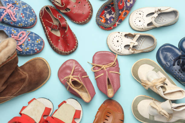 istock Many different children's shoes on a blue background. 2150775191