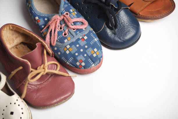 Many different children's shoes on white background.