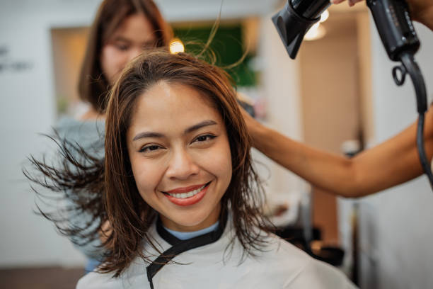 istock Smiling woman at hair salon 2150777949