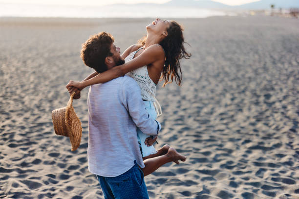 istock Carefree couple having fun on the beach. 2150782160