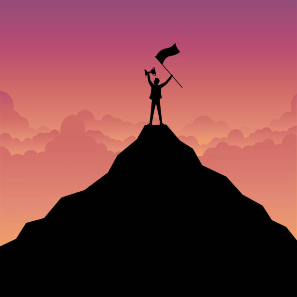 istock Silhouette of a businessman holding a trophy and flag on mountain 2150782616