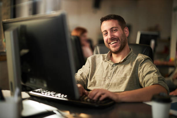 istock Happy male programmer working on PC in the office. 2150782659