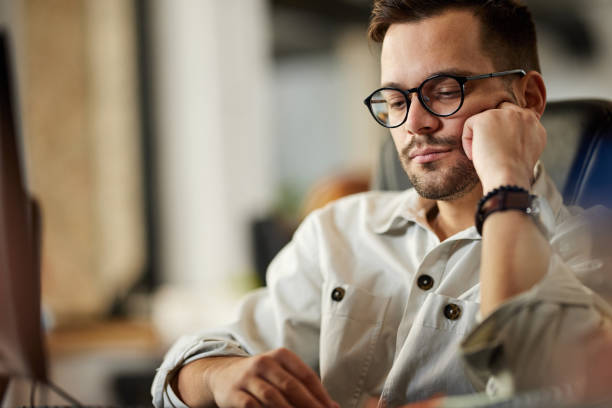 istock Bored businessman working in the office. 2150782734