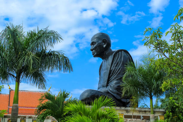 Black Monk Statue At Buddhist Temple ( called Wat Kaew Manee Si Mahathat) in Phang Nga Province, Thailand. Popular tourist destination for anyone traveling to Phang Nga or Phuket