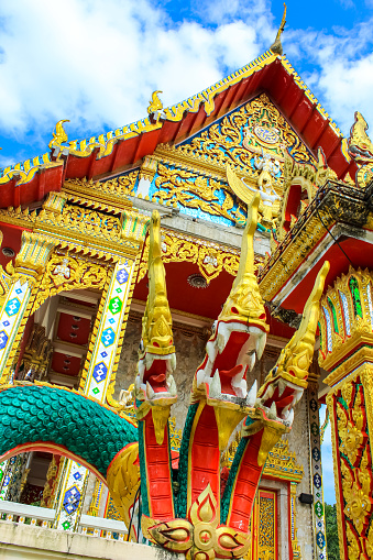 Buddhist temple Wat Kaew Manee Si Mahathat at sunny day in Phang Nga, Thailand, vertical background image