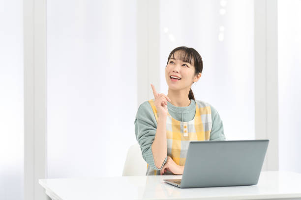istock A woman wearing an apron comes up with good ideas while working on a computer 2150786013