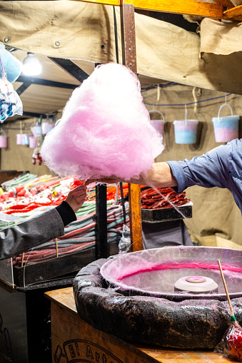 Cotton candy is a popular candy made of caramelized and colored sugar, served on a stick. It is a traditional treat at fairs, amusement parks and festive events.