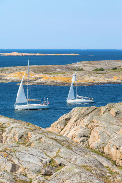 istock Sailboats sailing in rocky coast archipelago 2150786627