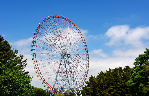 Large Ferris wheel against blue sky with copy space.