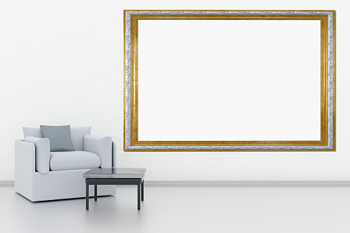 Frames, empty paintings on display on white wall. A frame with empty space for inserting text or images. Set in the living room. Silver and gold frame.