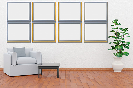 Frames, empty paintings on display on white wall. Eight frames with empty space for inserting text or images. Set in the living room. Silver and gold frames.