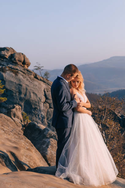 istock wedding couple walking in the mountains 2150788942