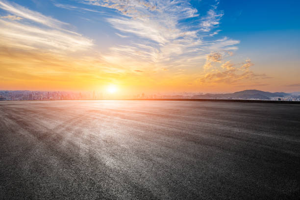 istock Asphalt square road and mountains with city skyline background 2150789099