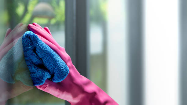 istock Human hand in protective glove wiping using a cloth 2150789127
